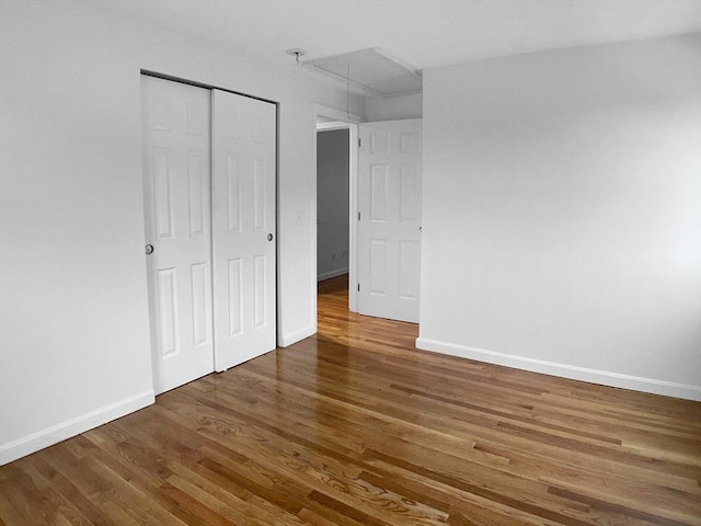 7 Nirvana Dr, Saugus, MA 01906 - unfurnished bedroom featuring wood finished floors, baseboards, a closet, and attic access