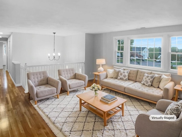 7 Nirvana Dr, Saugus, MA 01906 - living room with wood finished floors, a chandelier, plenty of natural light, and baseboards