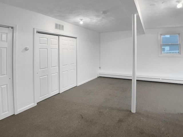 7 Nirvana Dr, Saugus, MA 01906 - below grade area with dark colored carpet, baseboards, and a baseboard heating unit