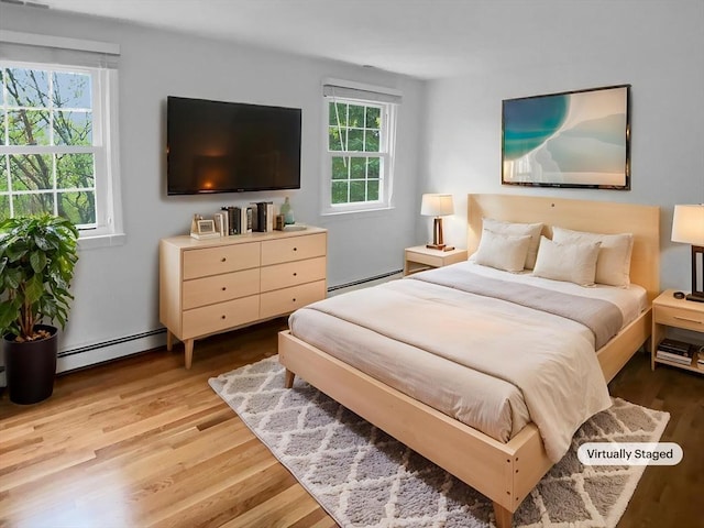 7 Nirvana Dr, Saugus, MA 01906 - bedroom with a baseboard radiator and wood finished floors