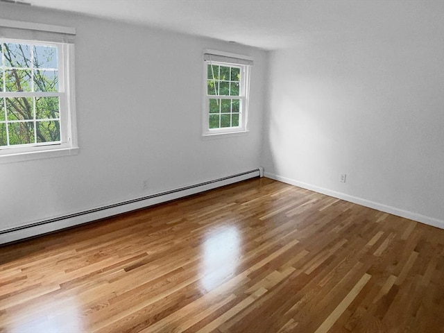 7 Nirvana Dr, Saugus, MA 01906 - unfurnished room featuring a baseboard heating unit, wood finished floors, and baseboards
