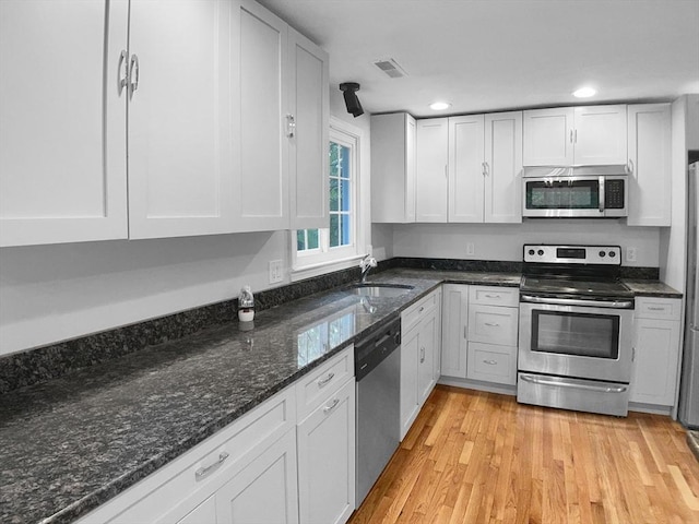 7 Nirvana Dr, Saugus, MA 01906 - kitchen featuring appliances with stainless steel finishes, a sink, light wood finished floors, white cabinets, and recessed lighting