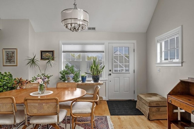 6 Essex Rd Unit 15, Ipswich, MA 01938 - dining area with an inviting chandelier, visible vents, light wood-style flooring, and lofted ceiling