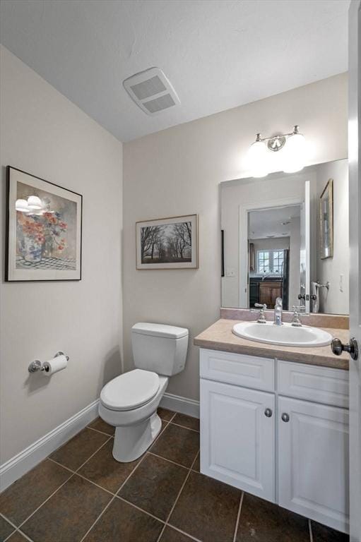 6 Essex Rd Unit 15, Ipswich, MA 01938 - half bath featuring tile patterned flooring, visible vents, vanity, toilet, and baseboards