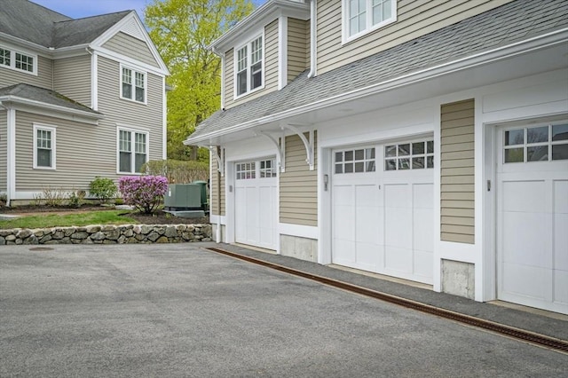 6 Essex Rd Unit 15, Ipswich, MA 01938 - garage with cooling unit and aphalt driveway