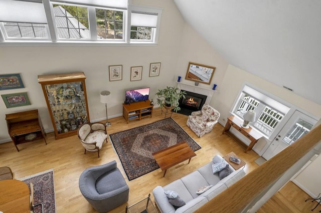 6 Essex Rd Unit 15, Ipswich, MA 01938 - living area with a glass covered fireplace, plenty of natural light, and wood finished floors