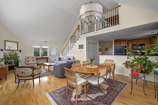 6 Essex Rd Unit 15, Ipswich, MA 01938 - dining room with stairs, high vaulted ceiling, a notable chandelier, and light wood finished floors