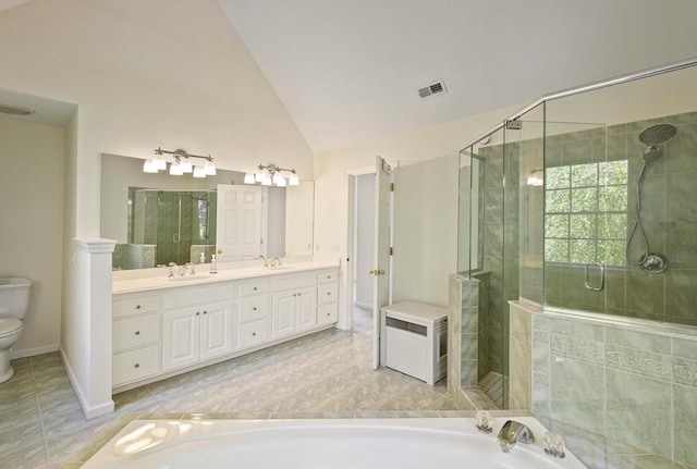 full bath featuring a sink, toilet, a shower stall, vaulted ceiling, and visible vents
