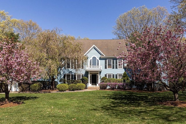 colonial home with a front yard