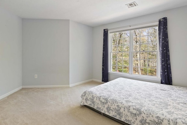 bedroom featuring baseboards, visible vents, multiple windows, and carpet