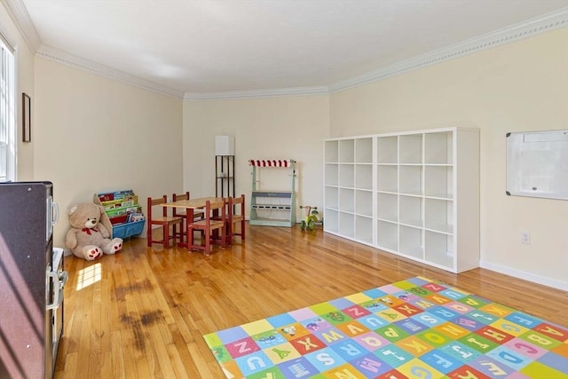 game room featuring ornamental molding and wood finished floors