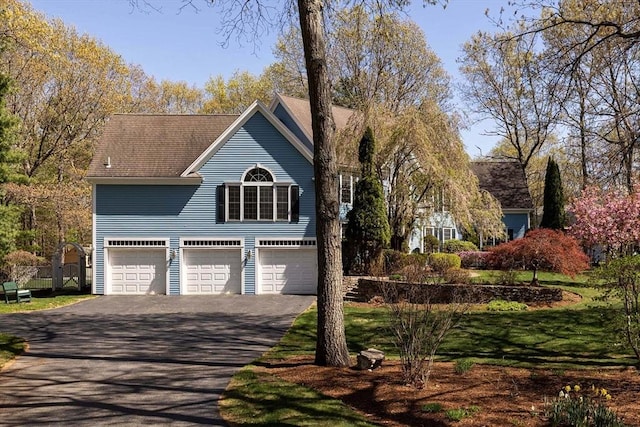 exterior space with a garage and aphalt driveway