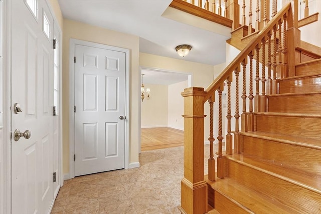 staircase featuring an inviting chandelier