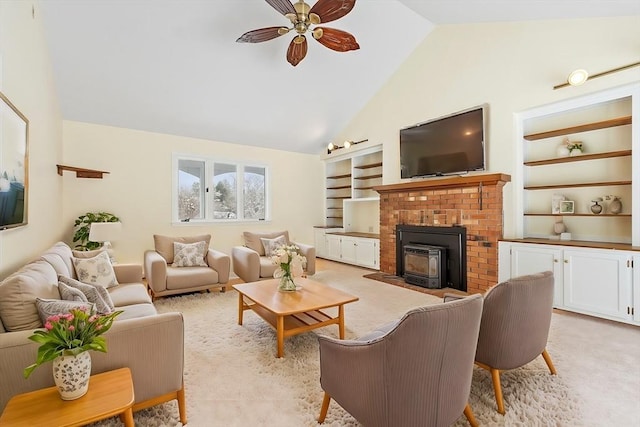 carpeted living room with ceiling fan, lofted ceiling, and built in features