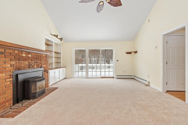 unfurnished living room with high vaulted ceiling, light carpet, a wood stove, baseboard heating, and ceiling fan