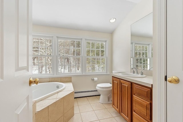 bathroom with tile patterned floors, toilet, vanity, a relaxing tiled tub, and a baseboard heating unit