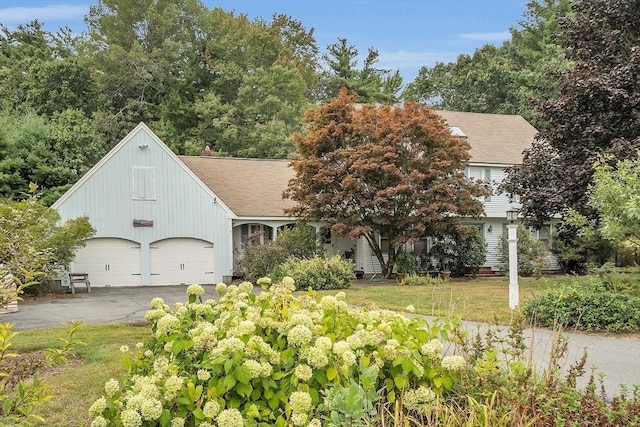 view of front of home with a garage and a front yard