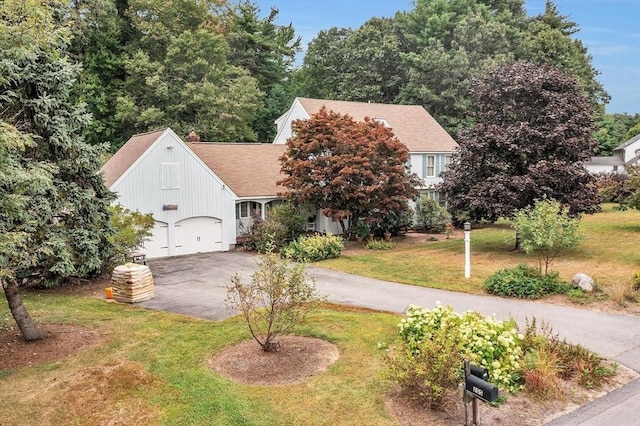 view of front facade with a garage and a front lawn