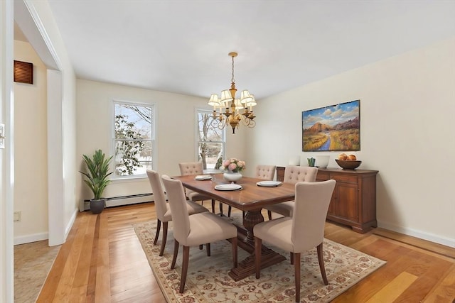 dining area featuring a notable chandelier, light hardwood / wood-style flooring, and baseboard heating