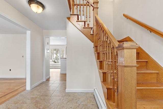 stairs featuring tile patterned flooring and a baseboard radiator