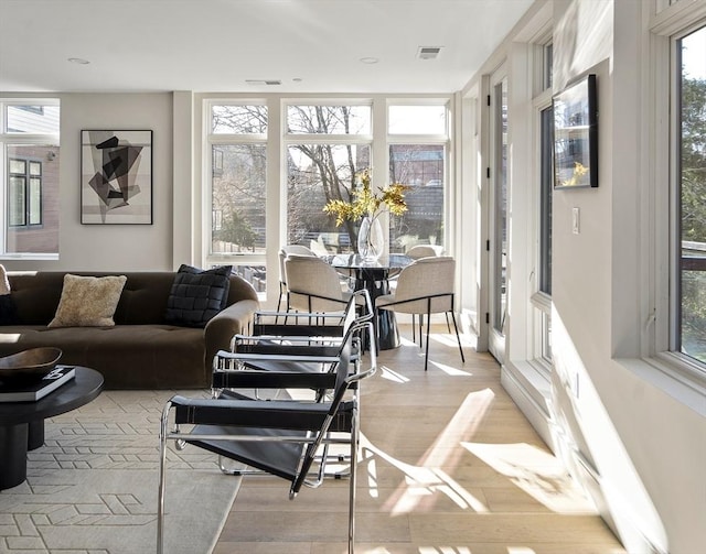 sunroom / solarium featuring a healthy amount of sunlight