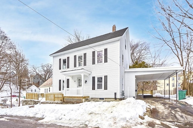 colonial-style house featuring a chimney