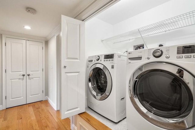 laundry room with laundry area, light wood-style floors, recessed lighting, and washer and dryer