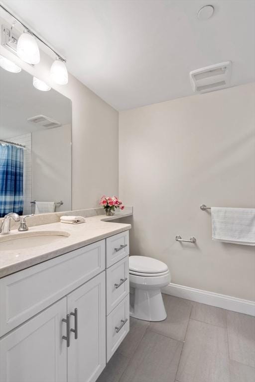 bathroom featuring visible vents, baseboards, toilet, tile patterned flooring, and vanity