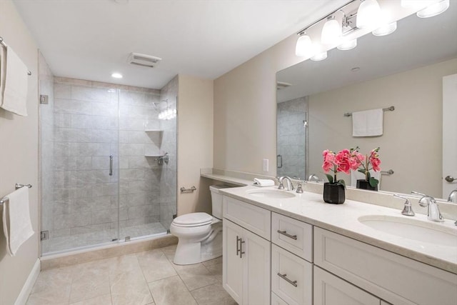 bathroom with a stall shower, a sink, and toilet