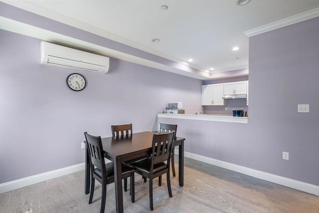 dining room featuring recessed lighting, baseboards, ornamental molding, a wall mounted AC, and a tray ceiling