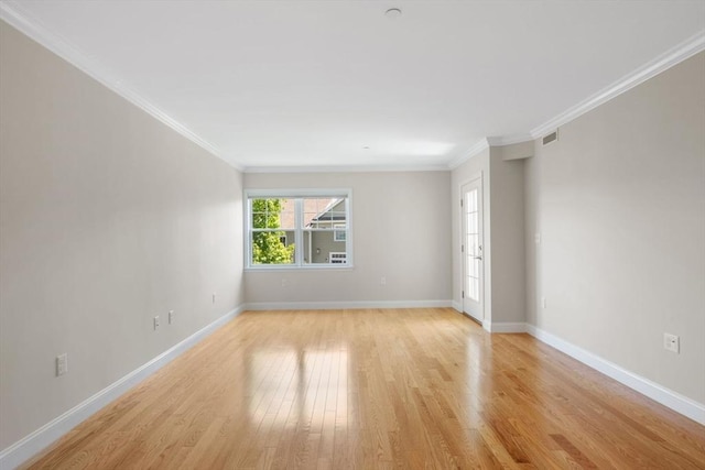 unfurnished room featuring ornamental molding, baseboards, and light wood finished floors