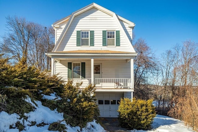 colonial inspired home with a garage and a gambrel roof