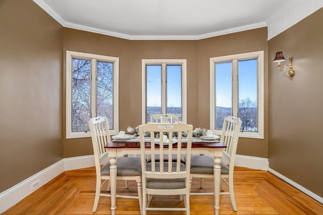 dining space with baseboards and ornamental molding