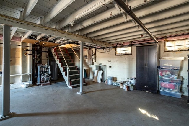 below grade area featuring stairway and a heating unit