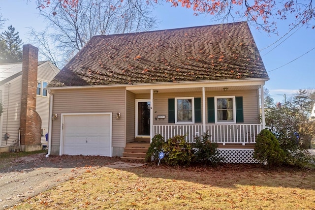 view of front of home with a porch, a garage, and a front yard