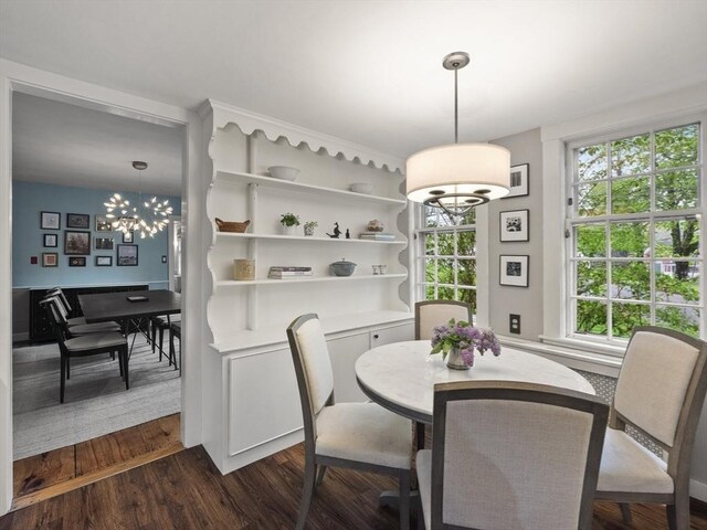 dining area featuring a chandelier and dark wood-style flooring
