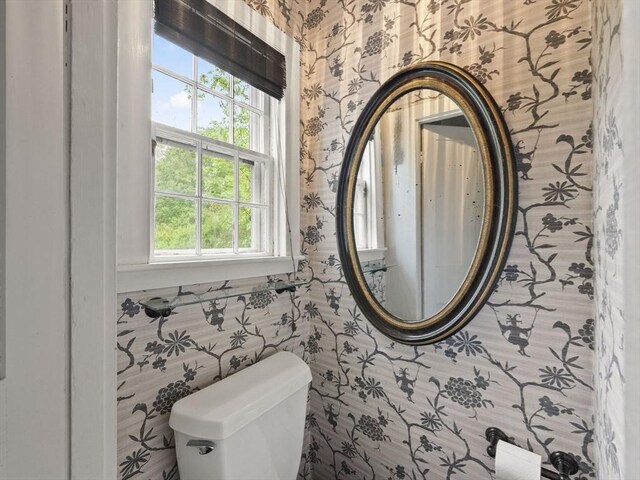 bathroom with wallpapered walls and toilet