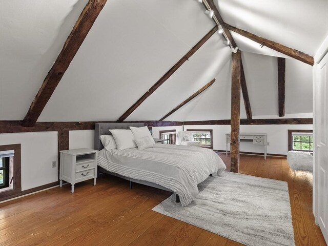 bedroom featuring hardwood / wood-style flooring and baseboards
