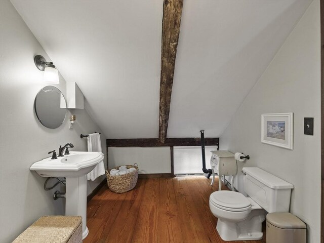 bathroom with toilet and wood finished floors