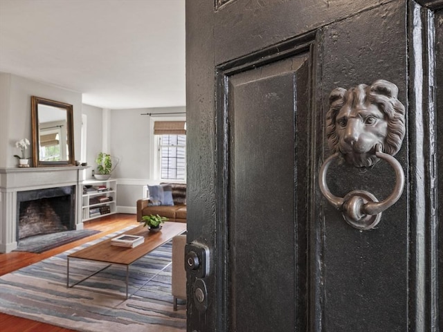 detailed view of wood finished floors and a fireplace