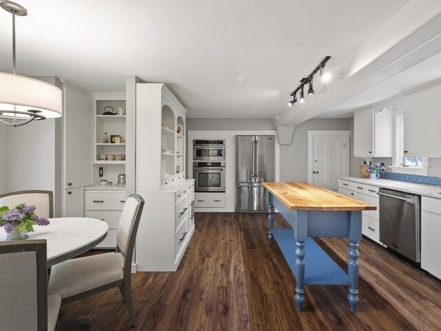 kitchen with stainless steel appliances, wooden counters, open shelves, dark wood-style floors, and white cabinets