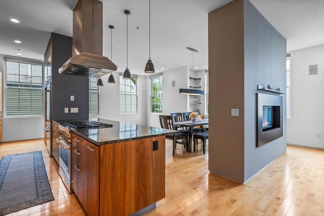 618 E 2nd St Unit 2, Boston, MA 02127 - kitchen with island exhaust hood, light wood-style floors, stainless steel appliances, dark stone counters, and recessed lighting