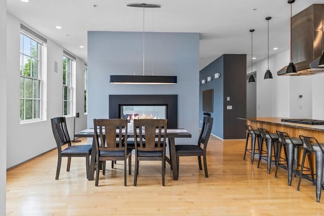 618 E 2nd St Unit 2, Boston, MA 02127 - dining space featuring light wood-style floors, recessed lighting, and a multi sided fireplace