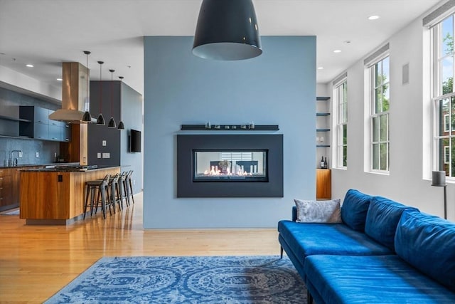 618 E 2nd St Unit 2, Boston, MA 02127 - living area featuring light wood-style flooring, recessed lighting, and a multi sided fireplace