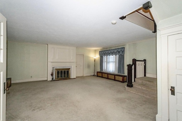 unfurnished living room with light colored carpet and a fireplace