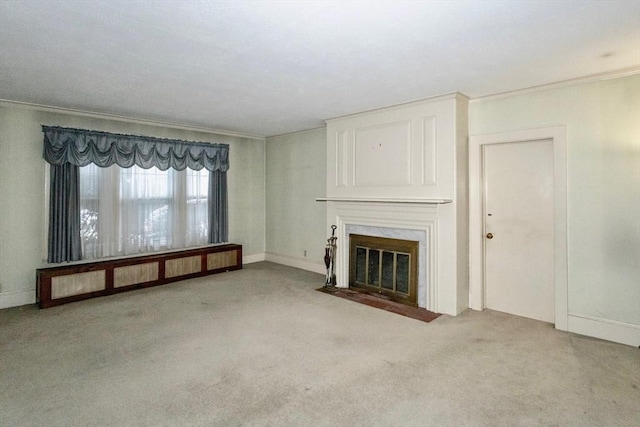 unfurnished living room with light carpet, ornamental molding, and a premium fireplace