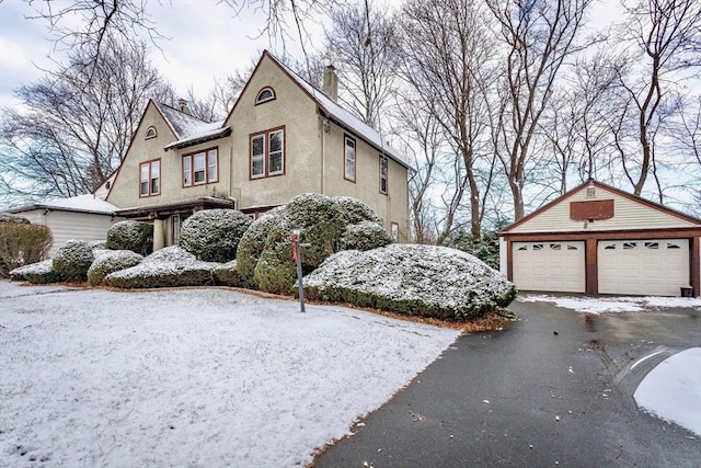 snow covered property with a garage