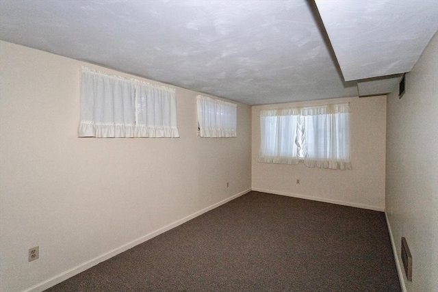 empty room with dark carpet