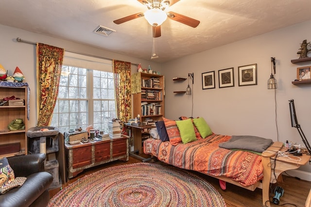 bedroom featuring dark hardwood / wood-style floors and ceiling fan