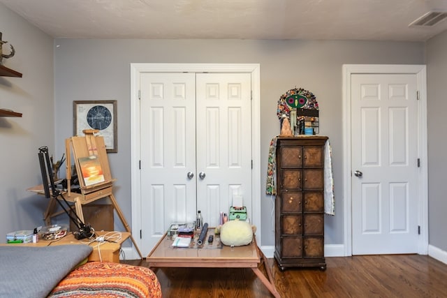 interior space with dark hardwood / wood-style floors and a closet